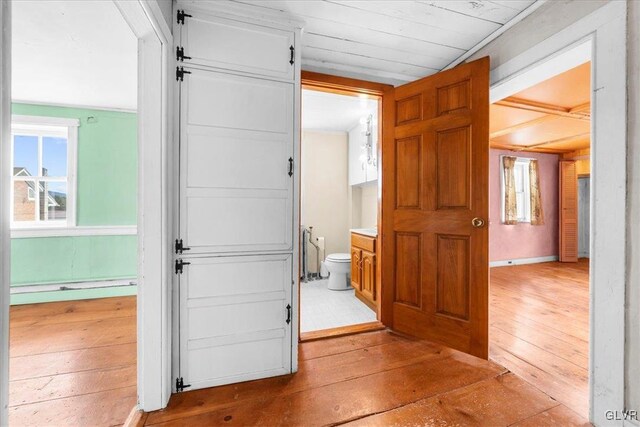 corridor with light hardwood / wood-style flooring