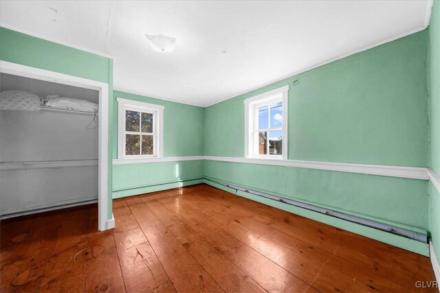 unfurnished bedroom featuring hardwood / wood-style floors and a closet