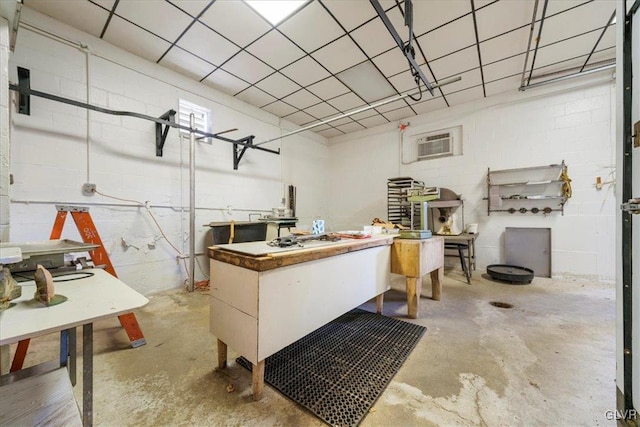 miscellaneous room featuring concrete floors and an AC wall unit