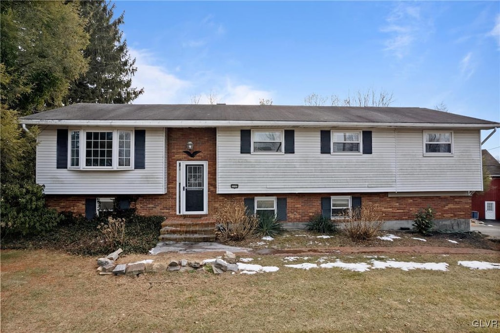 split foyer home with a front lawn