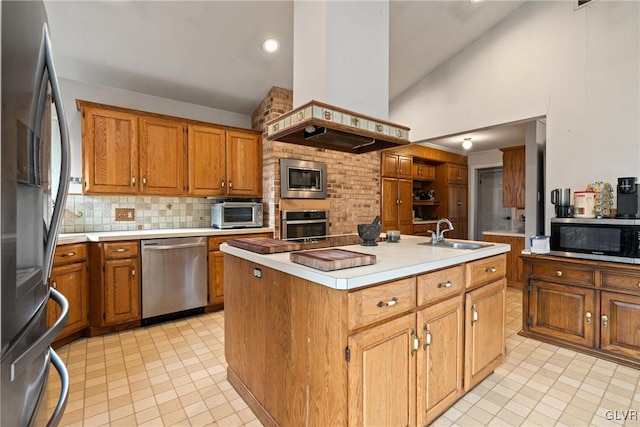 kitchen featuring sink, appliances with stainless steel finishes, a kitchen island with sink, island range hood, and decorative backsplash