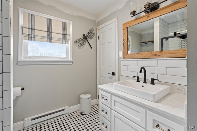 bathroom featuring vanity, a baseboard heating unit, and backsplash