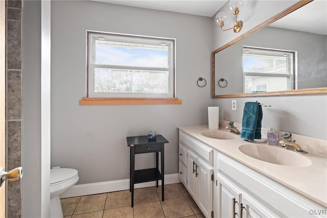 bathroom with vanity, plenty of natural light, tile patterned floors, and toilet