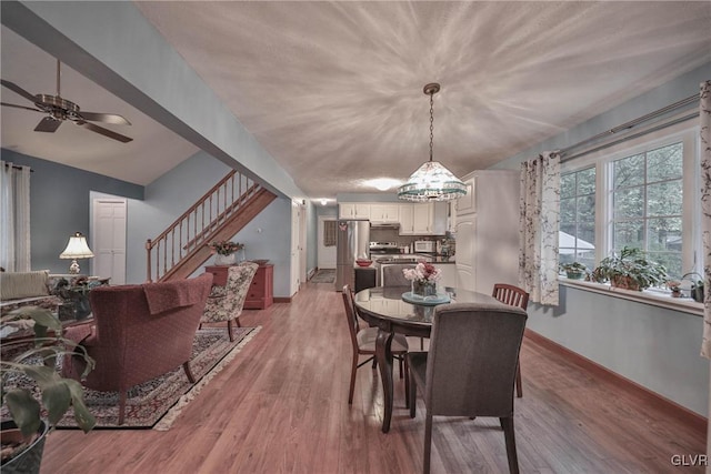 dining area with ceiling fan and light wood-type flooring