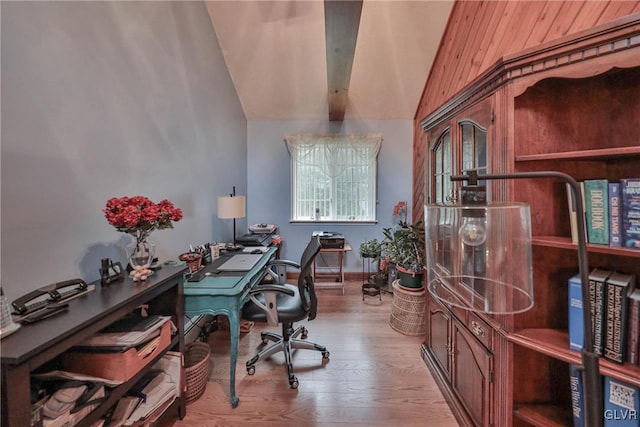 home office with vaulted ceiling and light hardwood / wood-style flooring