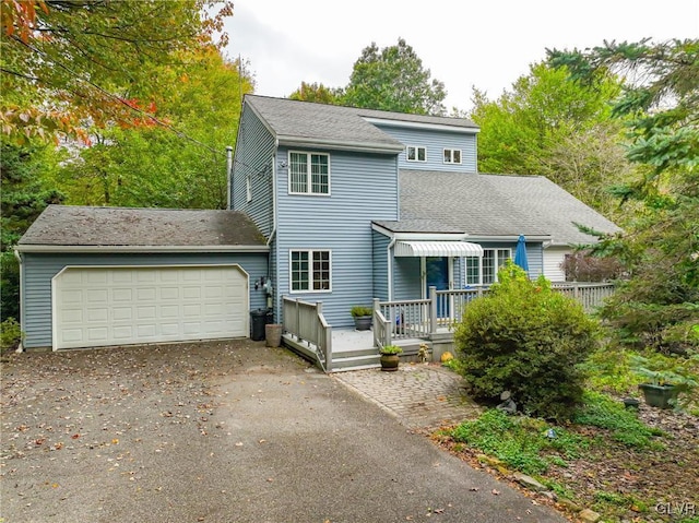 view of front of home featuring a wooden deck and a garage