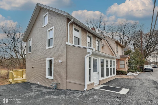 view of side of home featuring a sunroom