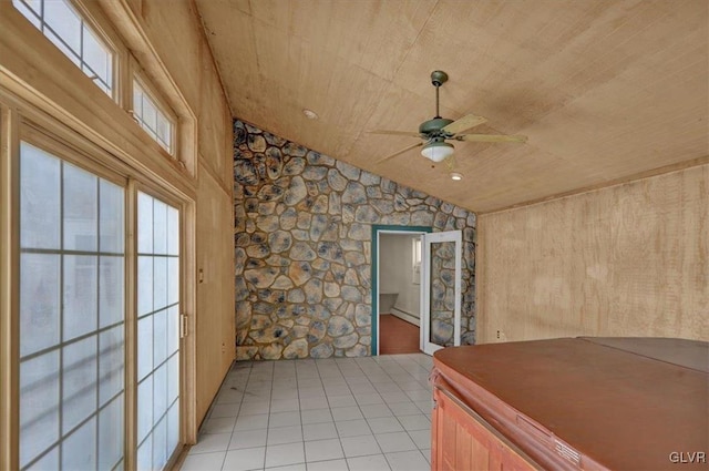 interior space featuring vaulted ceiling, light brown cabinetry, light tile patterned floors, ceiling fan, and wood ceiling