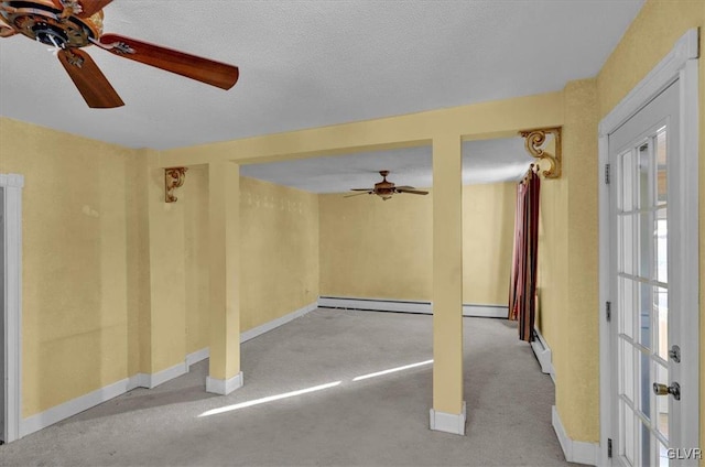 carpeted spare room featuring ceiling fan, a baseboard radiator, and a textured ceiling