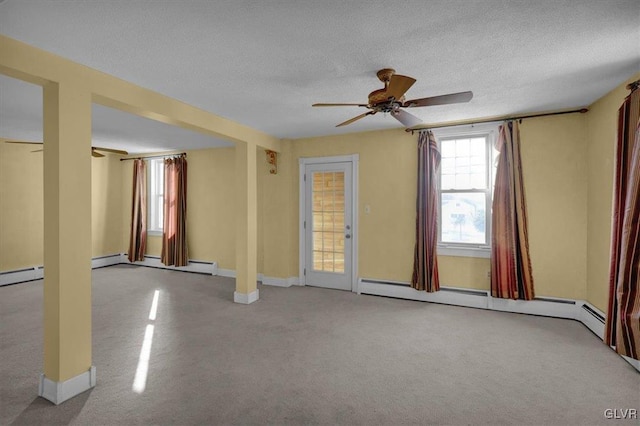 unfurnished room with a baseboard heating unit, light colored carpet, a textured ceiling, and ceiling fan