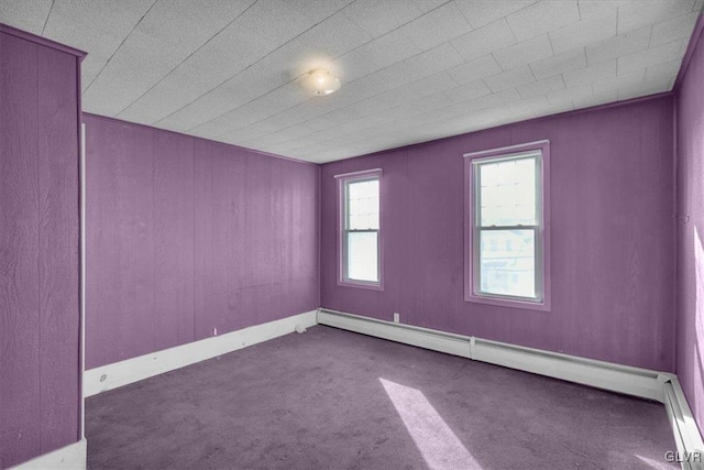 carpeted empty room with a baseboard radiator