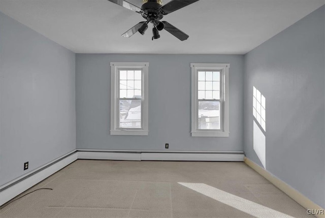 carpeted spare room featuring ceiling fan, a baseboard radiator, and a healthy amount of sunlight