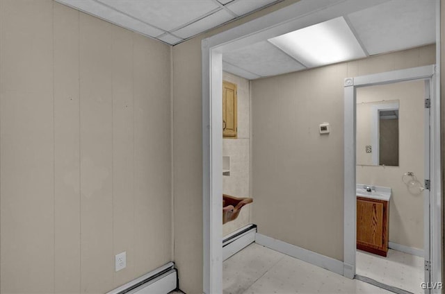 bathroom with vanity, a paneled ceiling, and baseboard heating