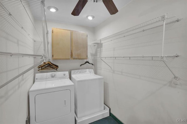 clothes washing area featuring cabinets, ceiling fan, and independent washer and dryer