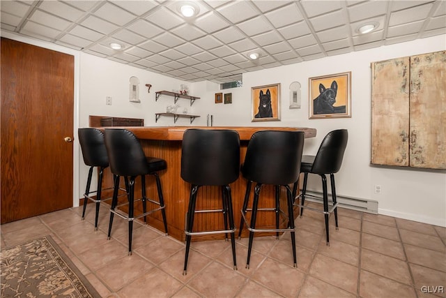 bar with light tile patterned floors and baseboard heating