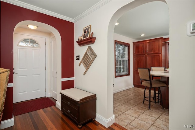 entrance foyer featuring ornamental molding and dark hardwood / wood-style floors