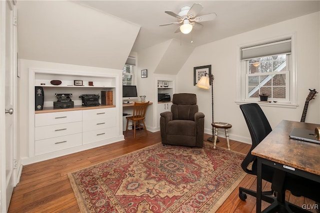 office space with vaulted ceiling, built in features, dark hardwood / wood-style floors, and ceiling fan