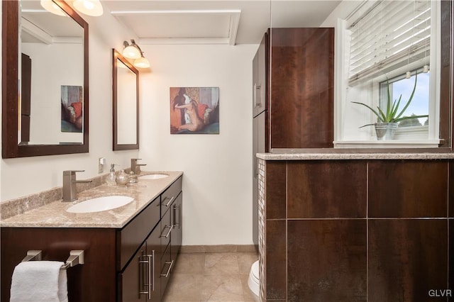 bathroom featuring vanity, tile patterned floors, and toilet