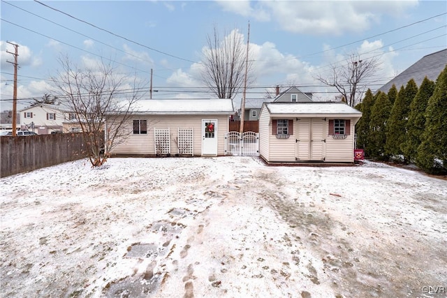 view of snow covered rear of property