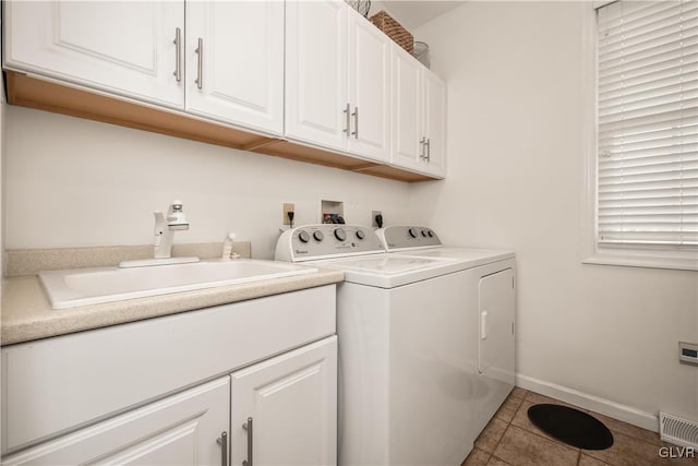 washroom with cabinets, light tile patterned flooring, separate washer and dryer, and sink