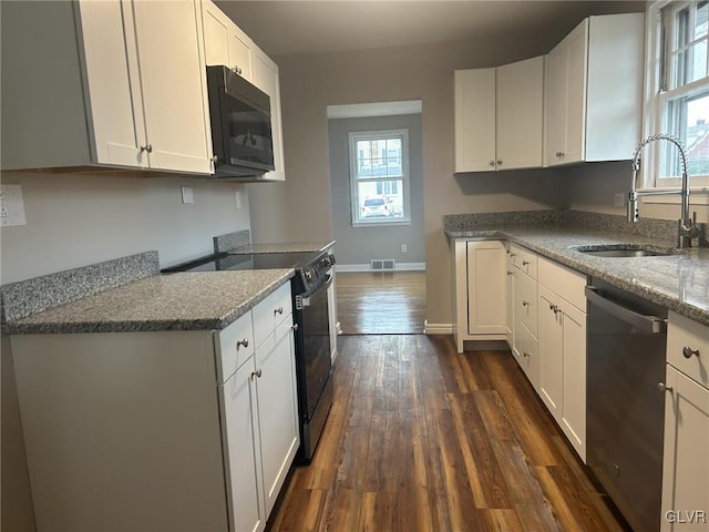 kitchen with sink, stone countertops, electric range, dishwasher, and white cabinets