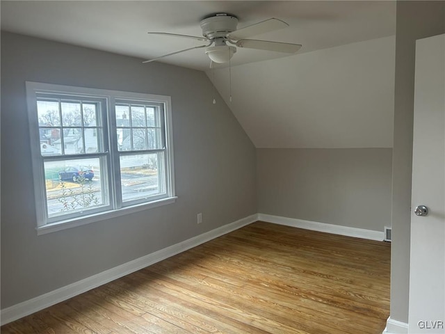 bonus room with lofted ceiling, light hardwood / wood-style flooring, and ceiling fan