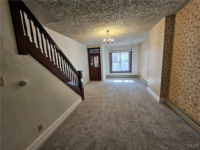 entryway with an inviting chandelier, a baseboard radiator, a textured ceiling, and carpet