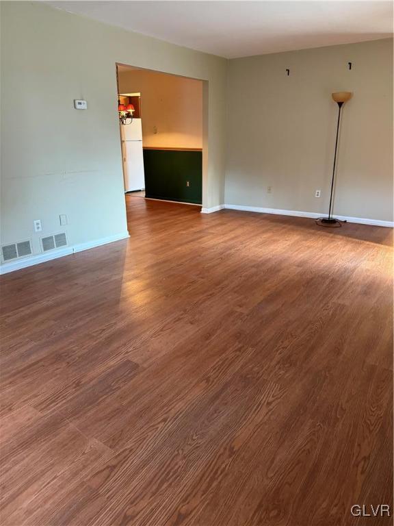 spare room with dark hardwood / wood-style flooring