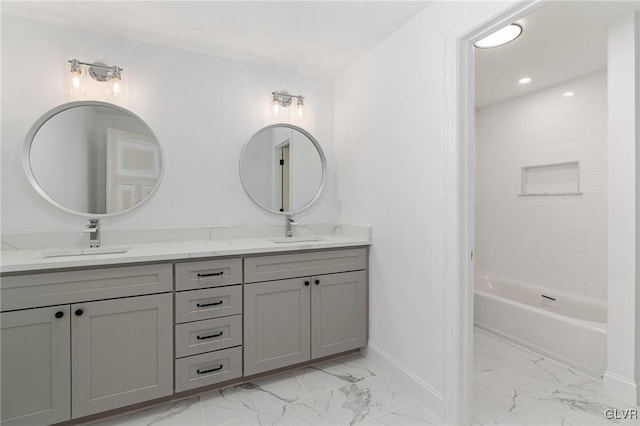 bathroom with tiled shower / bath and vanity