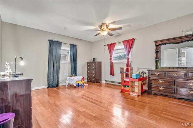 interior space featuring light hardwood / wood-style flooring, a baseboard radiator, and ceiling fan