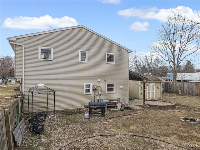 back of house with a patio and a storage unit