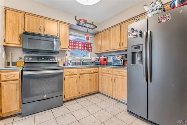 kitchen featuring stainless steel fridge with ice dispenser, range with electric stovetop, sink, and light tile patterned flooring