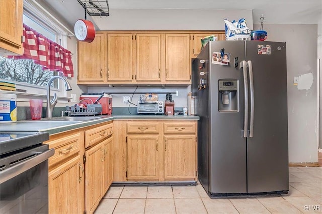 kitchen with stainless steel fridge with ice dispenser, light tile patterned floors, and sink