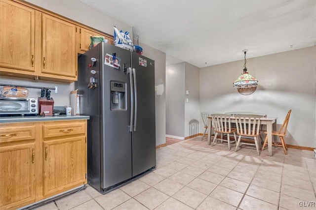 kitchen featuring hanging light fixtures, light tile patterned floors, and stainless steel fridge with ice dispenser