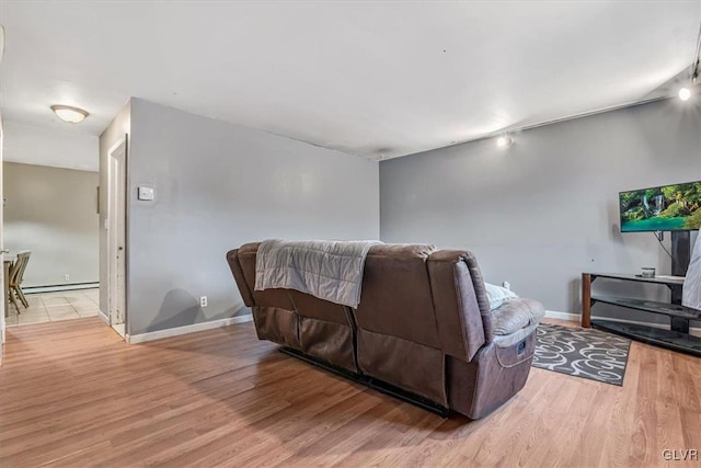 living room featuring light hardwood / wood-style flooring and baseboard heating