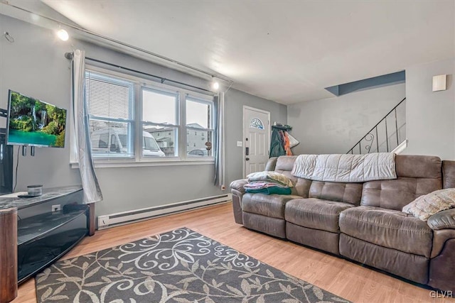 living room featuring a baseboard radiator and light hardwood / wood-style floors