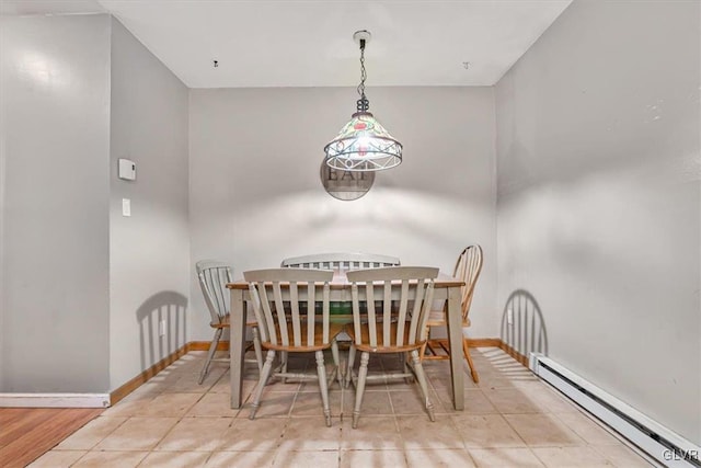 tiled dining area featuring a baseboard radiator