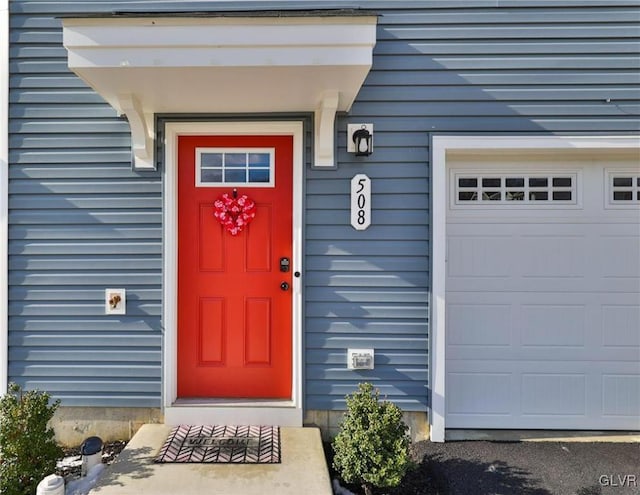 doorway to property with a garage