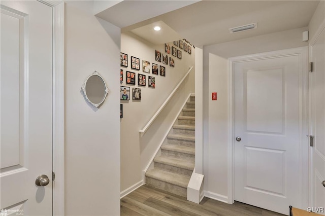 stairway with hardwood / wood-style floors