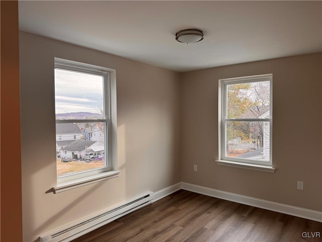 empty room with a baseboard radiator and wood-type flooring