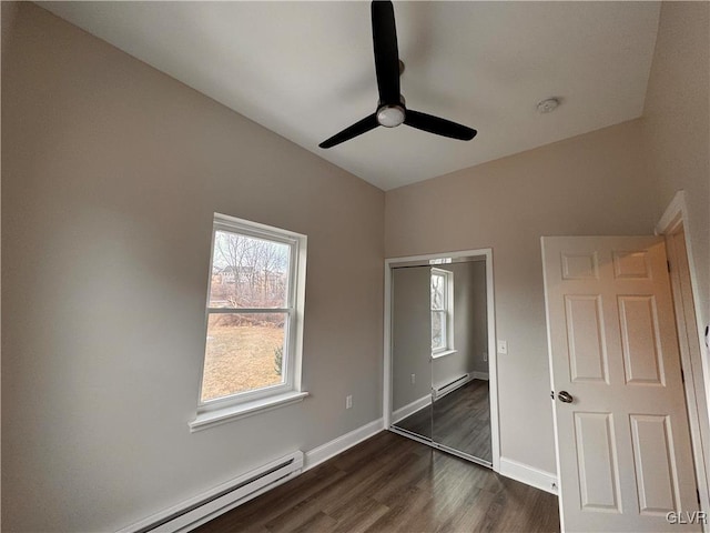 unfurnished bedroom with a baseboard radiator, ceiling fan, and dark hardwood / wood-style flooring