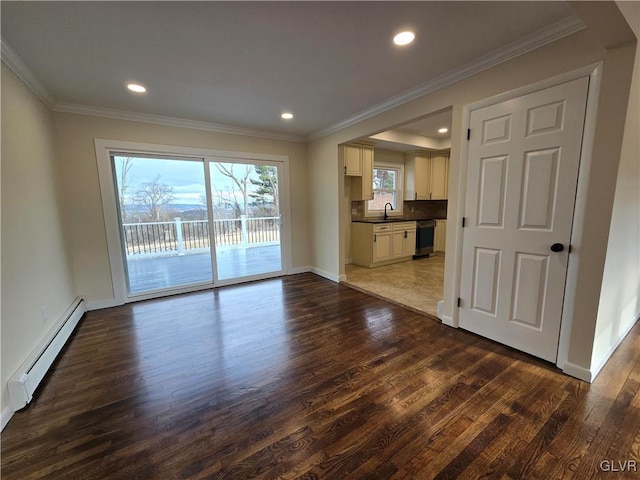 unfurnished living room featuring dark wood-type flooring, crown molding, sink, and a baseboard heating unit