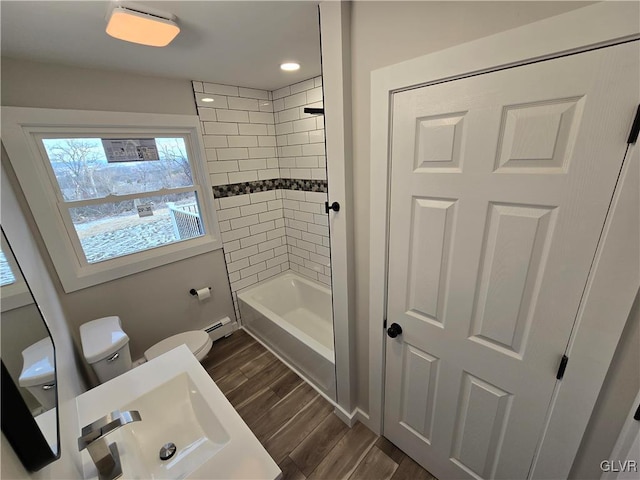 full bathroom with sink, tiled shower / bath, and toilet