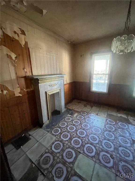 unfurnished living room with wooden walls