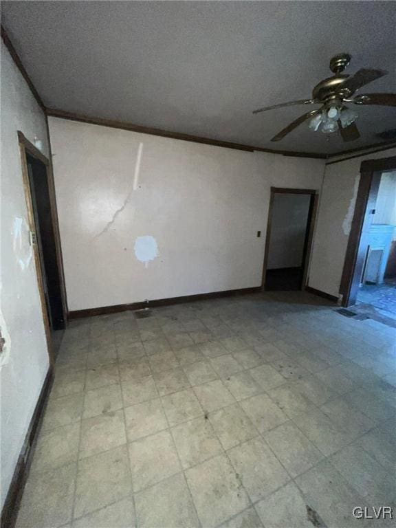 empty room featuring ceiling fan, ornamental molding, and a textured ceiling