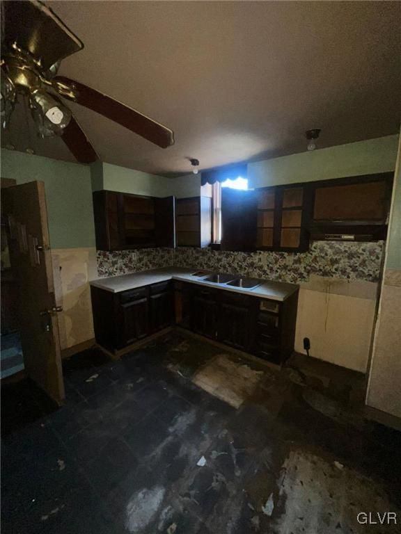 kitchen with dark brown cabinets, sink, and decorative backsplash