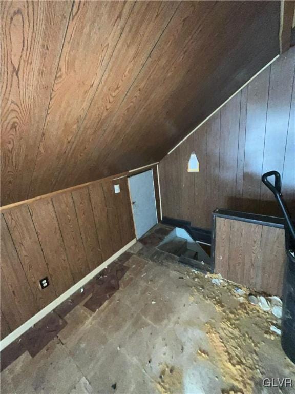 bonus room featuring lofted ceiling, wooden ceiling, and wood walls