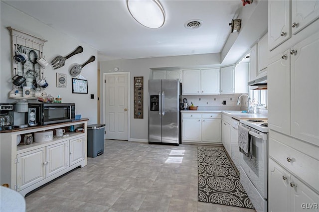 kitchen featuring backsplash, stainless steel appliances, sink, and white cabinets