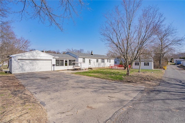 ranch-style home with a garage and a front yard