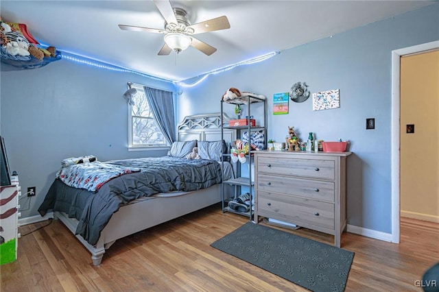 bedroom with ceiling fan and hardwood / wood-style floors